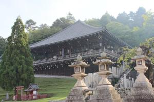 a building in a park with some statues in front of it at Nara Guesthouse 3F in Nara