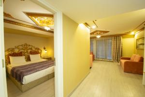 A bed or beds in a room at Empire Suite Hotel