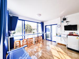 a kitchen and dining room with a table and chairs at Blue House in Ang Thong