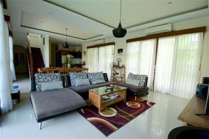 a living room with a couch and a table at Villa Aurikari in Legian