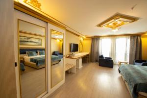 A bed or beds in a room at Empire Suite Hotel