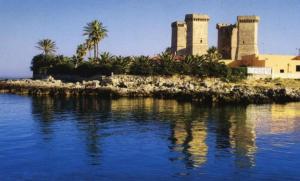 an island in the water with palm trees and buildings at B&B Filieri in Santa Maria al Bagno