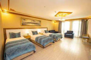 A bed or beds in a room at Empire Suite Hotel