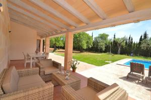 Un patio con sillas y una mesa y una piscina. en 138 Finca Els Olivers ET1083 by Mallorca Charme, en Alcudia