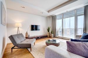 a living room with a couch and a tv at Vilnius Apartments & Suites in Vilnius