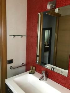 a bathroom with a white sink and a mirror at La casetta di Simone in Cassino