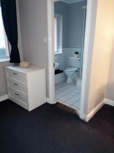 a bathroom with a toilet and a sink at Youghal in Youghal