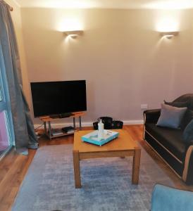 a living room with a couch and a coffee table at Youghal in Youghal