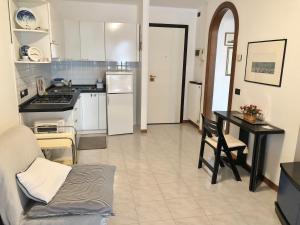 a kitchen with a table and a stove top oven at Villa Marta in Grado