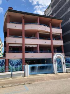 a building with a blue fence in front of it at Villa Marta in Grado