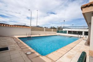 a swimming pool on the roof of a building at El aparta de Ampa in Playa de Gandia