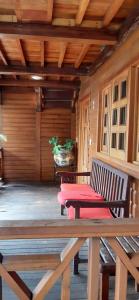 a porch with a picnic table and a bench at Cabañas La Finca in Atlixco