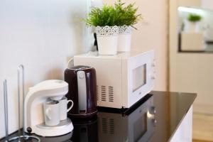 a microwave sitting on top of a counter with plants at Apartament Nadmorskie Wzgórze in Mechelinki