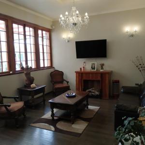 uma sala de estar com um sofá e uma televisão em Hotel Restaurante Aconcagua em La Ligua