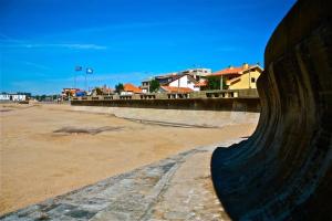 a skateboard ramp on a beach with buildings in the background at Villa Granja Sol in São Félix da Marinha