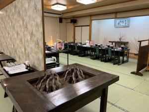 a room with tables and chairs in a classroom at Ryokan Murayama in Takayama