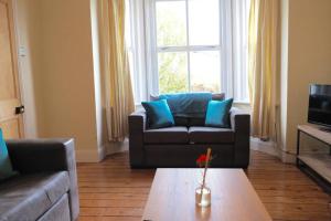 a living room with a couch and a coffee table at Self contained stylish city home in Norwich