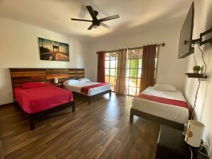 a bedroom with a bed, chair and a tv at Cancun-Soho B&B in Cancún