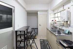 a kitchen with a sink and a counter at G&R House 201 in Tokyo