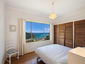 a bedroom with a bed and a large window at Otway Blue in Wye River