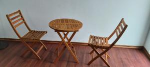 two wooden chairs and a table in a room at Haven Seaview Homestay in Lanyu