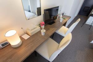 a room with a long wooden table and chairs at BEEHIVE APARTMENT Moriguchi in Osaka