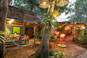 a palm tree in front of a restaurant at Under The Coconut Tree Hoi An Homestay in Hoi An