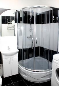 a bathroom with a shower with a toilet and a sink at Apartments on Sobornaya,9 - Sotka in Mykolaiv
