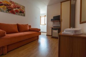 a living room with a couch and a television at Villa Confort Exclusive in Rovinj
