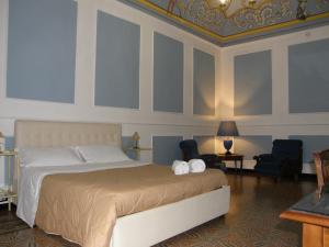 a bedroom with a bed with two white towels on it at Il Gattopardo House in Catania