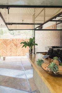 a kitchen with a counter with a bowl of pineapples on it at The Nuga House in Ahangama