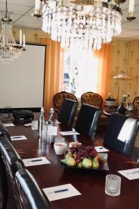 a conference room with a long table with food on it at Högbo Hotell Skommarsgården in Sandviken