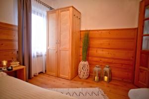 a bedroom with a bed and a cabinet and a potted plant at Willa Przy Skoczni in Zakopane