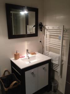 a bathroom with a white sink and a mirror at Studio calme, lumineux, terrasse, WIFI, 1.5 Km du front de mer in Saint-Nazaire