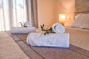 a hotel room with two towels on a bed at Costas apartments in Mesongi