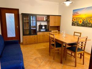 a kitchen and dining room with a wooden table and chairs at La Riviera in Loreo