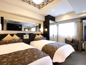 Postel nebo postele na pokoji v ubytování APA Hotel Chiba Ekimae