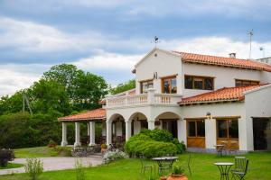 a large white house with a red roof at Hosteria La Caldera in La Caldera