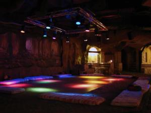 a room with a stage with colored lights in it at Queen Sharm Aqua Park Hotel in Sharm El Sheikh