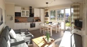 a living room with a couch and a table at Haus Seeteufel in Zingst