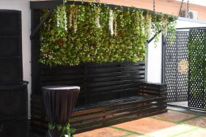 a hanging garden with flowers on a black fence at 247 Luxury Hotel in Lekki