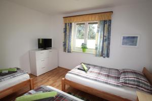 a living room with two beds and a window at HH-Apartments in Scheifling