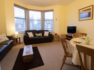 a living room with a couch and a table at Star Fish Apartment in Weymouth