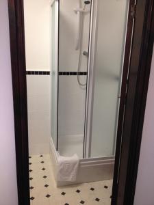 a shower with a glass door in a bathroom at New Masons Arms in Leeds