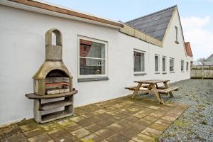 a building with a pizza oven next to a picnic table at Just Sleep in Esbjerg