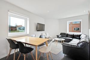 a living room with a table and a couch at Just Sleep in Esbjerg