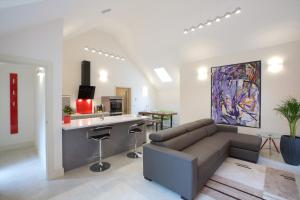 a living room with a couch and a kitchen at Railway Apartments in Nailsworth