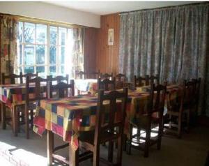 a dining room with tables and chairs and a window at Hotel Royal in San Clemente del Tuyú