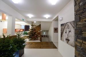 a christmas tree in the middle of a hallway at Pensjonat Orla Perc in Zakopane