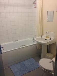 a bathroom with a tub, toilet and sink at Royal Chambers Liverpool in Liverpool